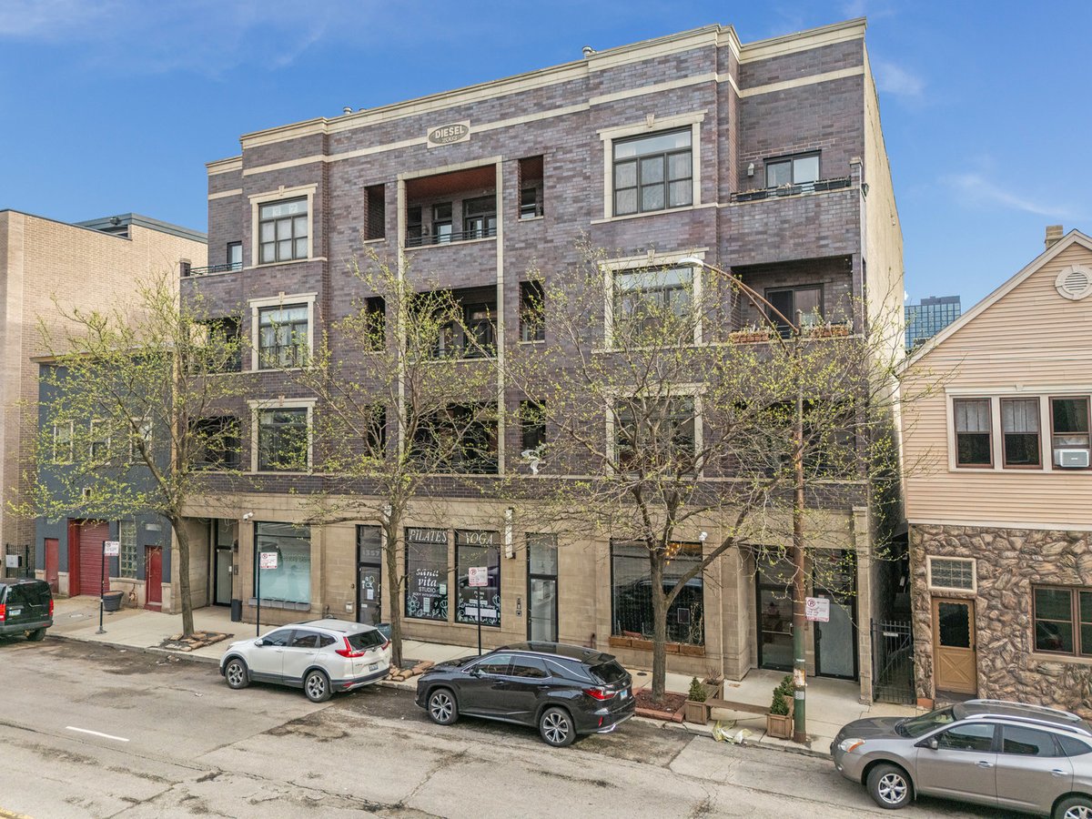 Front exterior of the brick building at 1359 W Grand Ave, Chicago in West Town